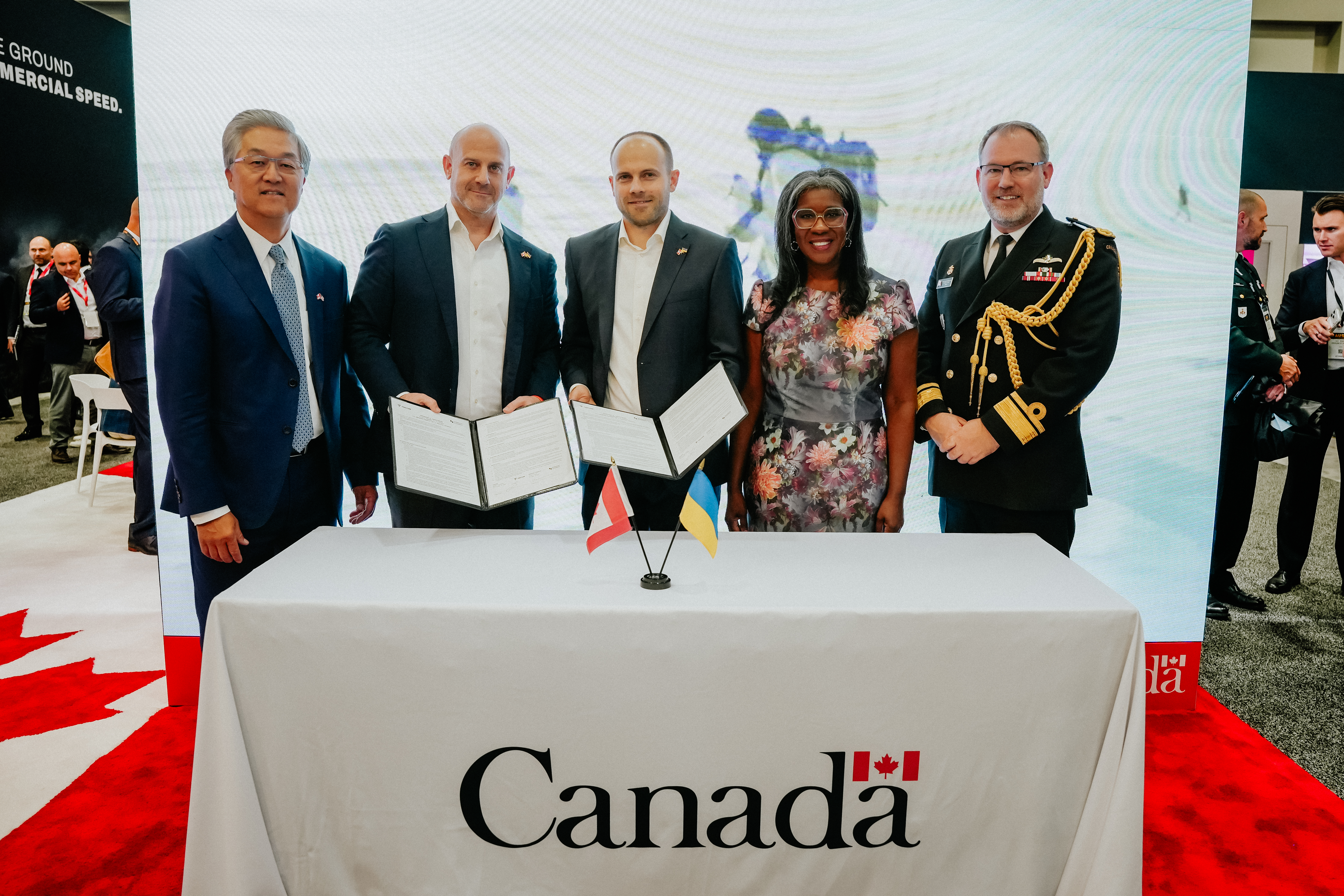 From left: Bobby Kwon of the Canadian Commercial Corporation (CCC); Eliot Pence, Founder and CEO of Dominion Dynamics; Roman Tkachenko, Co-founder of TENCORE, Nadia Theodore, Canada's Deputy Ambassador to the United States; and Rear-Admiral Kristjan Monaghan, Canada’s Defence Attaché to the United States, at the signing of a memorandum of understanding between Dominion Dynamics and TENCORE.